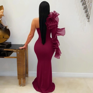 Detailed back view of a burgundy one-shoulder dress with layered organza ruffle sleeve