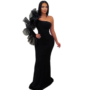 Detailed view of the layered organza ruffle on the shoulder of the black evening dress