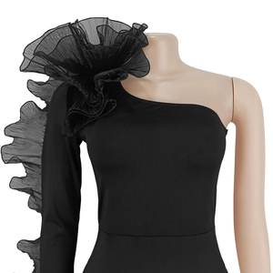Detail view of dramatic black mesh ruffles on a one-shoulder bodycon dress sleeve
