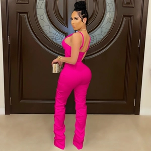 Detail of rose pink slim fit bodysuit featuring low back design and stacked leg hem style
