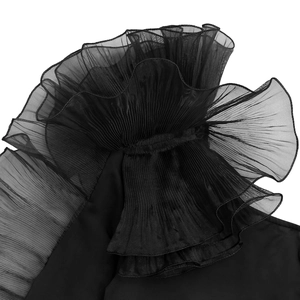 Close-up of black mesh dress featuring elegant pleated ruffles and tiered gauze texture