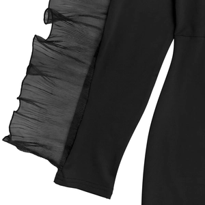 Detail of elegant black dress showing pleated mesh ruffles and high-quality stitching