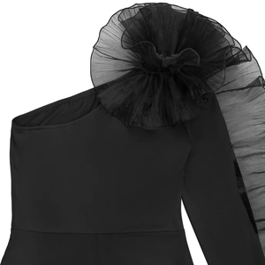 Close-up of elegant pleated mesh flower detail on one-shoulder black dress strap