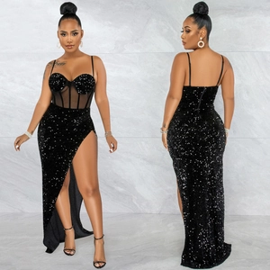 Detail of black sequined evening dress with sheer mesh panels and high side slit