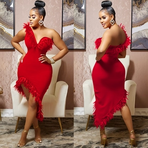 Detailed view of red one-shoulder dress with elegant feather trim and asymmetric hemline