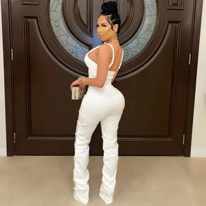 Detail of white two-piece set featuring slim fit crop top and stacked ruched high waist pants