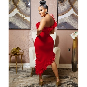 Detail of red one-shoulder party dress featuring elegant feather trim and asymmetric hemline