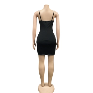 Detail of black bodycon mini dress featuring delicate pearl embellishments on back seams