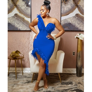 Detail of royal blue one-shoulder dress featuring premium feather trim and asymmetrical hem