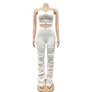 Detail of white two-piece set featuring zippered crop top and ruched high-waist pants