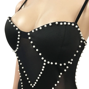 Detail of black mesh corset top with white faux pearl embellishments along the bust line