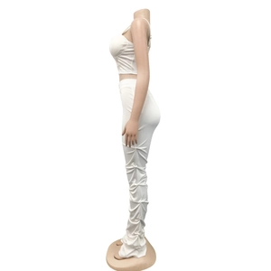 Detailed side view of white two-piece set featuring stacked design slim pants and crop top