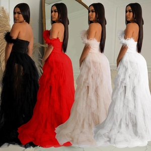 Elegant strapless mesh maxi dress with feather trim in black, red, pink, and white colors