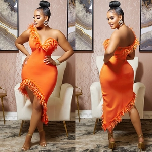 Detail view of the orange V-neck bodycon dress with ostrich feather trim and asymmetric hem