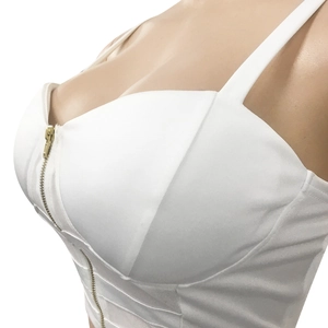 Close-up of white cropped tank top featuring a vertical gold metal front zipper detail