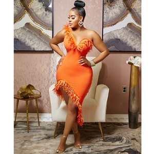 Detail of orange one-shoulder party dress featuring high-density feather trim and asymmetric hem
