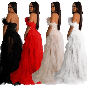 Detail view of strapless tulle gown with feather trim and layered tiered skirt