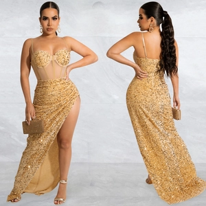 Macro detail of a gold sequin evening dress featuring a high slit and sheer mesh insert