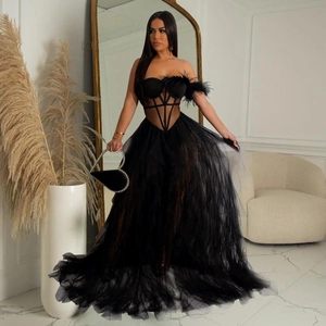 Elegant black strapless evening gown with feather detail and layered mesh tutu skirt