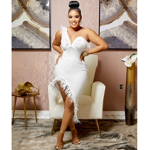 Detail of elegant white one-shoulder dress with ostrich feather trim and irregular hem