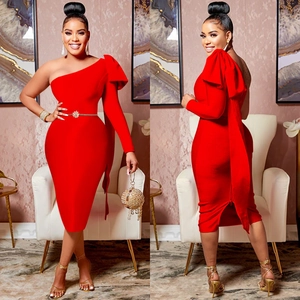 Detail view of red one-shoulder midi dress featuring a large bow and gold floral belt