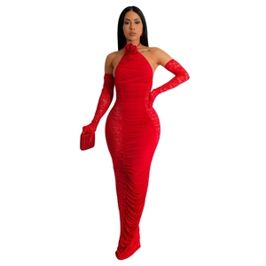 Detail of red halter dress with 3D rose ornament, ruching fabric, and lace side panels