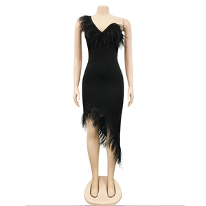 Detail of the black feather trim and asymmetrical hem on the slim one-shoulder dress
