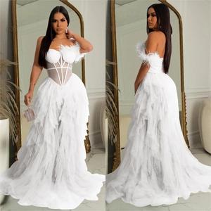 Detailed views of a white strapless tulle dress with feather trim and corset bodice