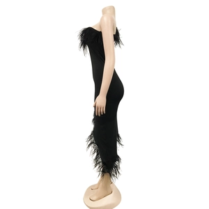Close-up of black feather trim details on the neckline and hem of the bodycon midi dress