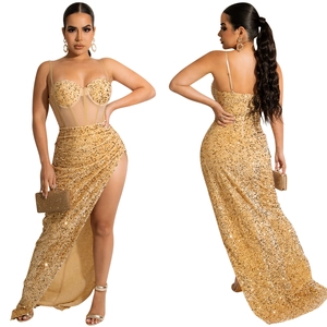 Detailed view of luxury gold sequin corset dress with high slit and sheer mesh texture