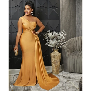 Detail showing the pleated waist and flowing side train of a gold satin one-shoulder dress