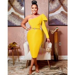 Detail of a one-shoulder bodycon dress in yellow with a dramatic bow on the shoulder