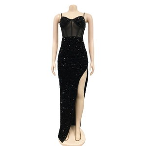 Detail of black sequined dress featuring heart-shaped neckline and sheer tulle inserts