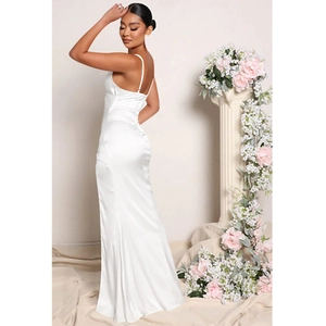 Detail view of white satin long dress with elegant slit and cross-back straps design