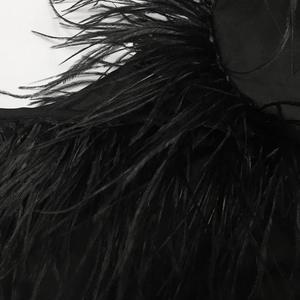 Detail shot of premium black ostrich feathers on a V-neck sleeveless irregular midi dress