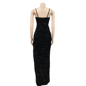 Detailed back view of a slim-fit black sequin gown with thin straps and a long hemline