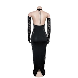 Detail view of backless black dress with lace patchwork and matching lace gloves