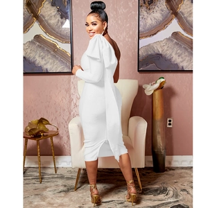 Detail of white one-shoulder slim dress with large ruffle bow and ruched texture