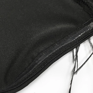 Detail of black dress featuring non-slip silicone strip and elegant feather trim accents