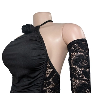 Detail of black halter dress featuring fabric rose and intricate floral lace sleeves