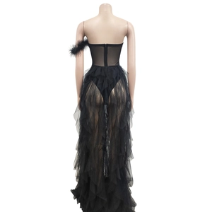 Detailed back view of strapless black tulle maxi dress with ruffles and feather accents