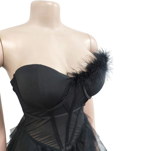 Detail of black strapless corset with feather neckline and tiered mesh tulle layers