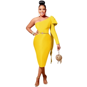 Detail of elegant one shoulder yellow dress featuring a large bow and gold belt