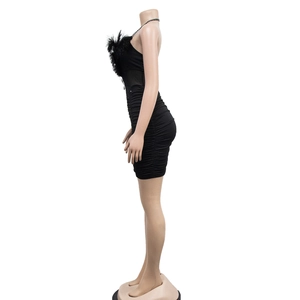 Detail view of stylish black tube mini dress with luxurious feather trim on the neckline
