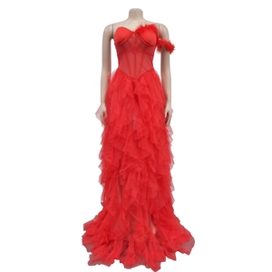 Close-up of red strapless evening gown featuring mesh layers and feather detailing