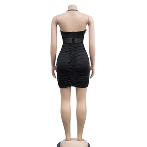 Detail view of the ruched back design and sheer mesh panel with feather trim on a black dress