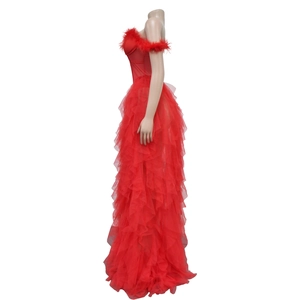 Detail of red strapless evening gown featuring a feathered neckline and layered tulle skirt
