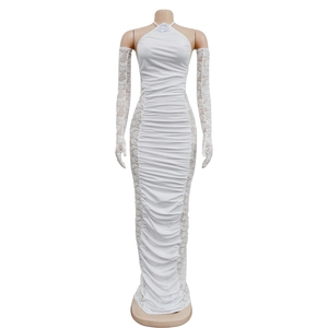 Close-up of white halter dress featuring elegant pleated fabric and floral lace side panels