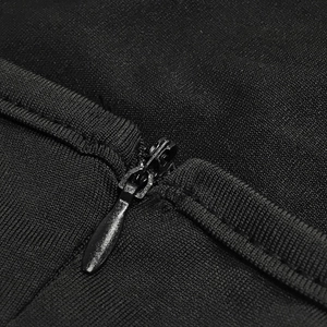 Detail shot of a hidden zipper and fine stitching on a black one-shoulder dress