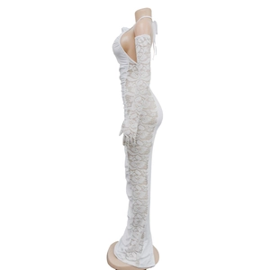 Detail of white evening dress featuring sheer lace patterns and matching long lace gloves